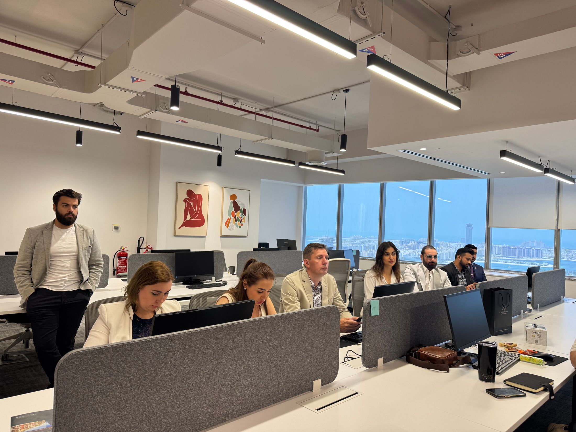 Professionals collaborating in a modern Dubai office meeting