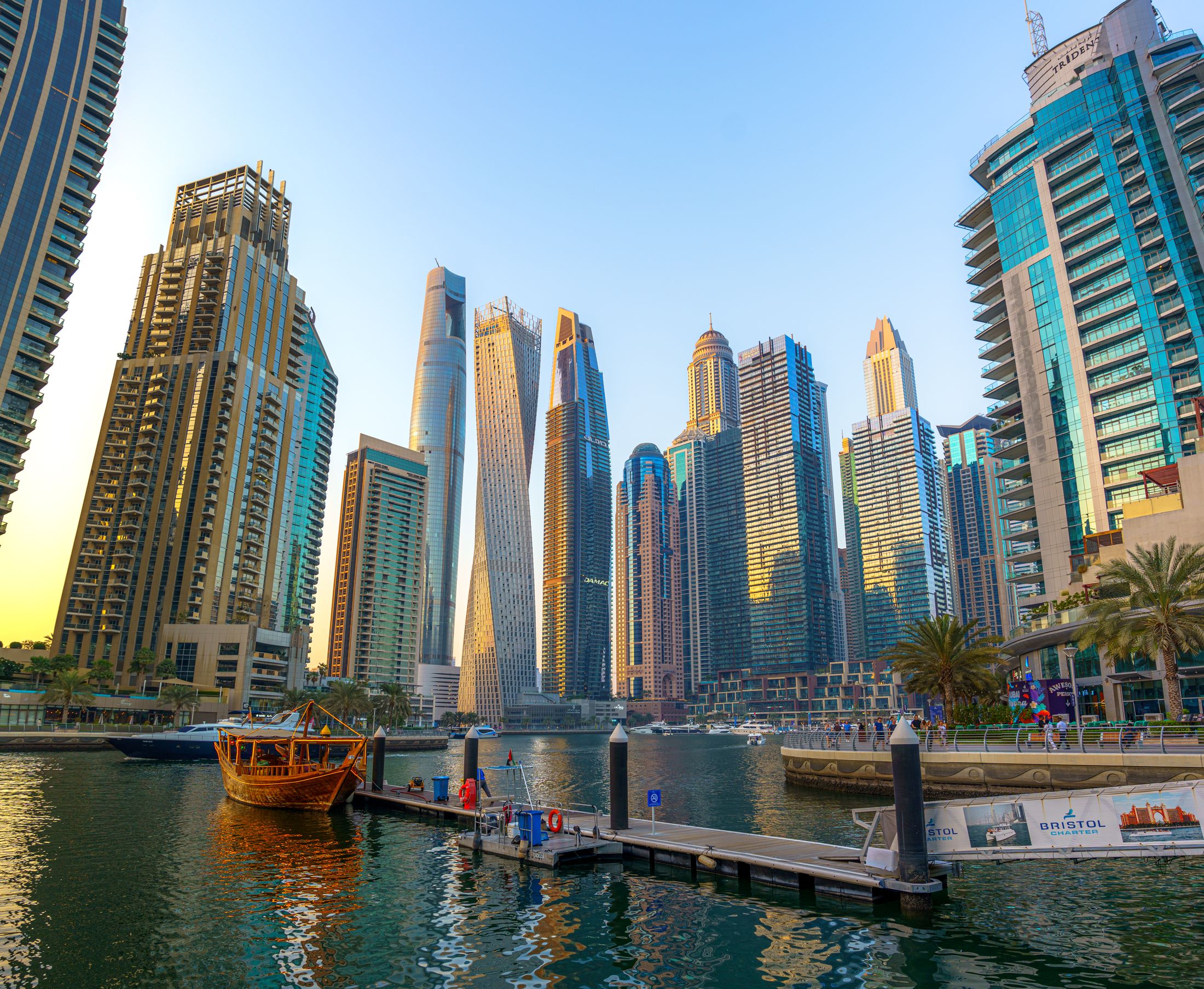 Traditional dhow on Dubai Marina with the city skyline behind it